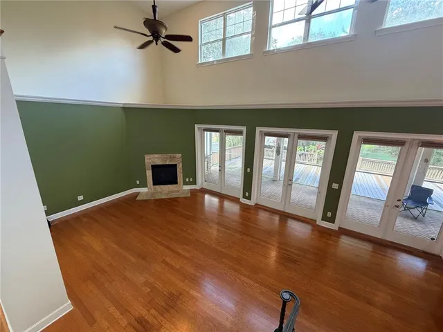 a bathroom with a toilet a sink a mirror a vanity and shower
