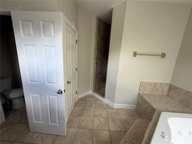 a view of backyard with a deck and wooden floor