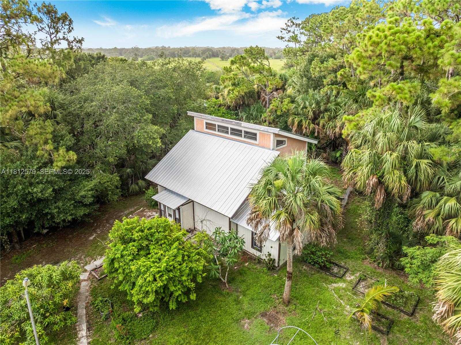 7900 Southwest Springhaven Avenue Indiantown, FL 34956 - Photo 1 of 38 a view of a house with a yard and sitting area