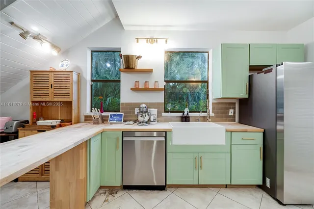 a kitchen with a sink and a refrigerator