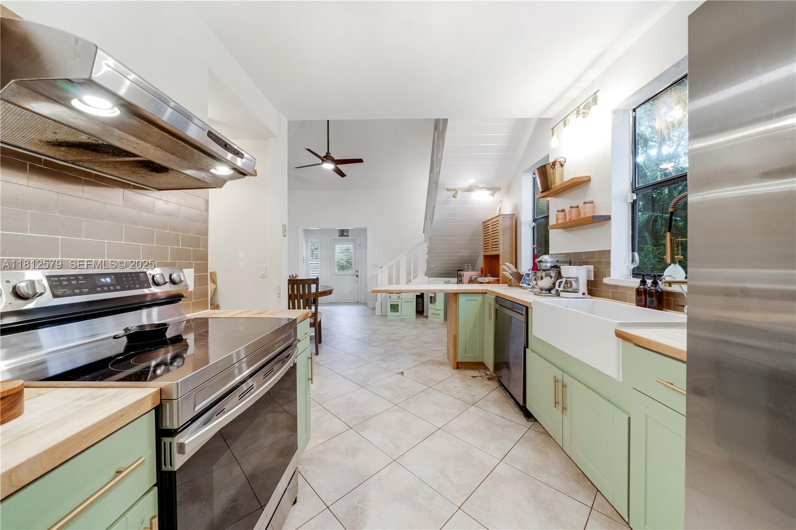 7900 Southwest Springhaven Avenue Indiantown, FL 34956 - Photo 13 of 38 a kitchen with a stove and a sink