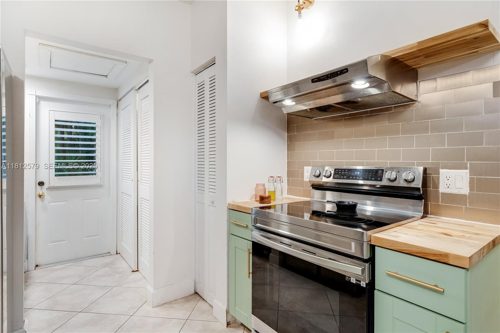 7900 Southwest Springhaven Avenue Indiantown, FL 34956 - Photo 14 of 38 a kitchen with a stove and a cabinet