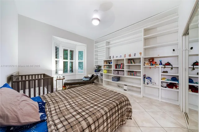 a bedroom with a bed and a book shelf