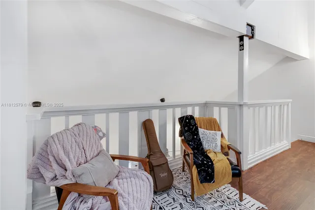 a living room with furniture rug and a window