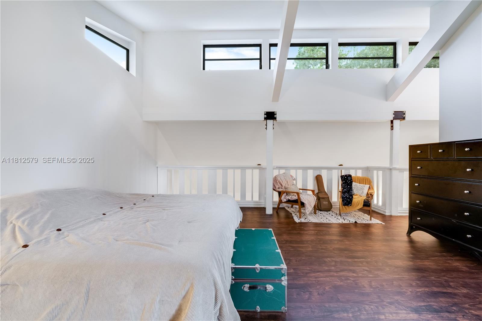 7900 Southwest Springhaven Avenue Indiantown, FL 34956 - Photo 20 of 38 a living room with lots of furniture and a wooden floor