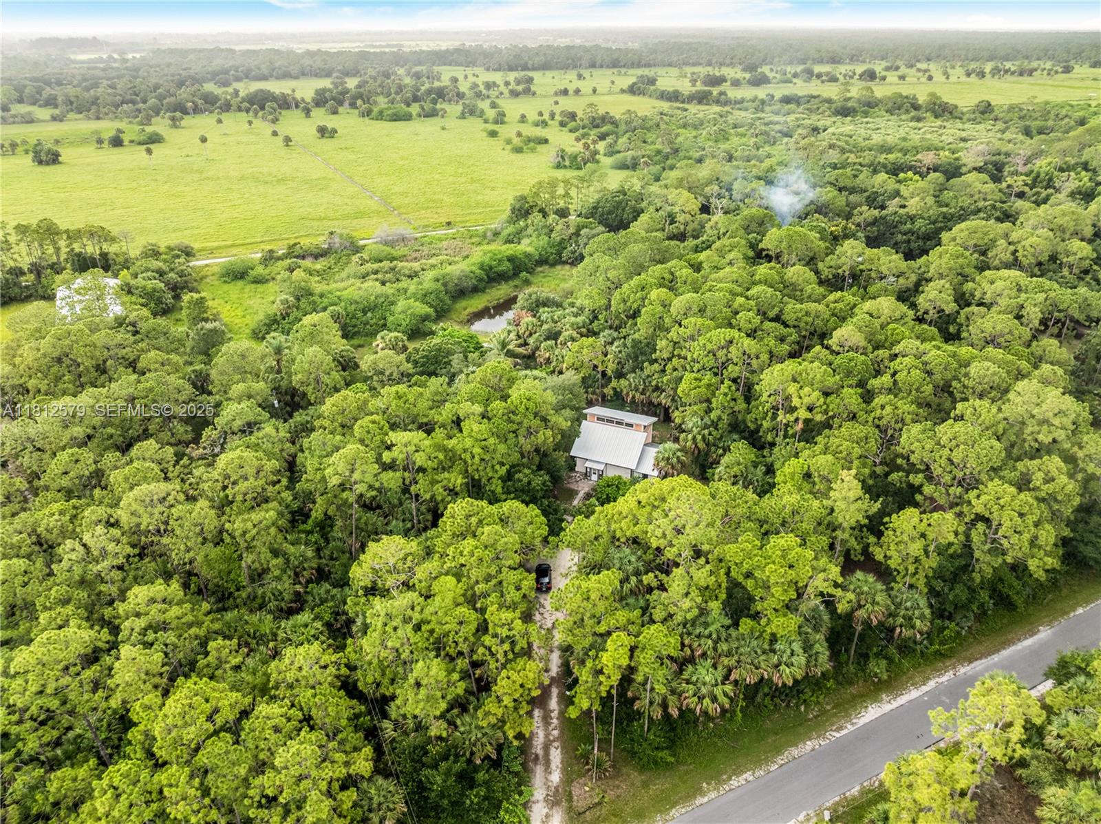 7900 Southwest Springhaven Avenue Indiantown, FL 34956 - Photo 2 of 38 a view of a lake with a house