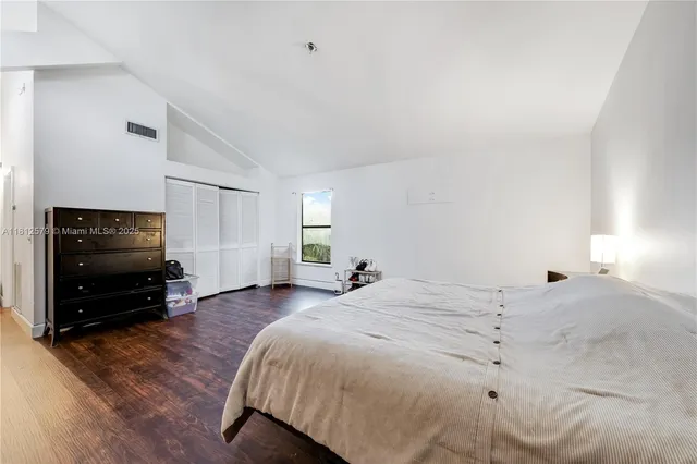 a bedroom with a bed and a television