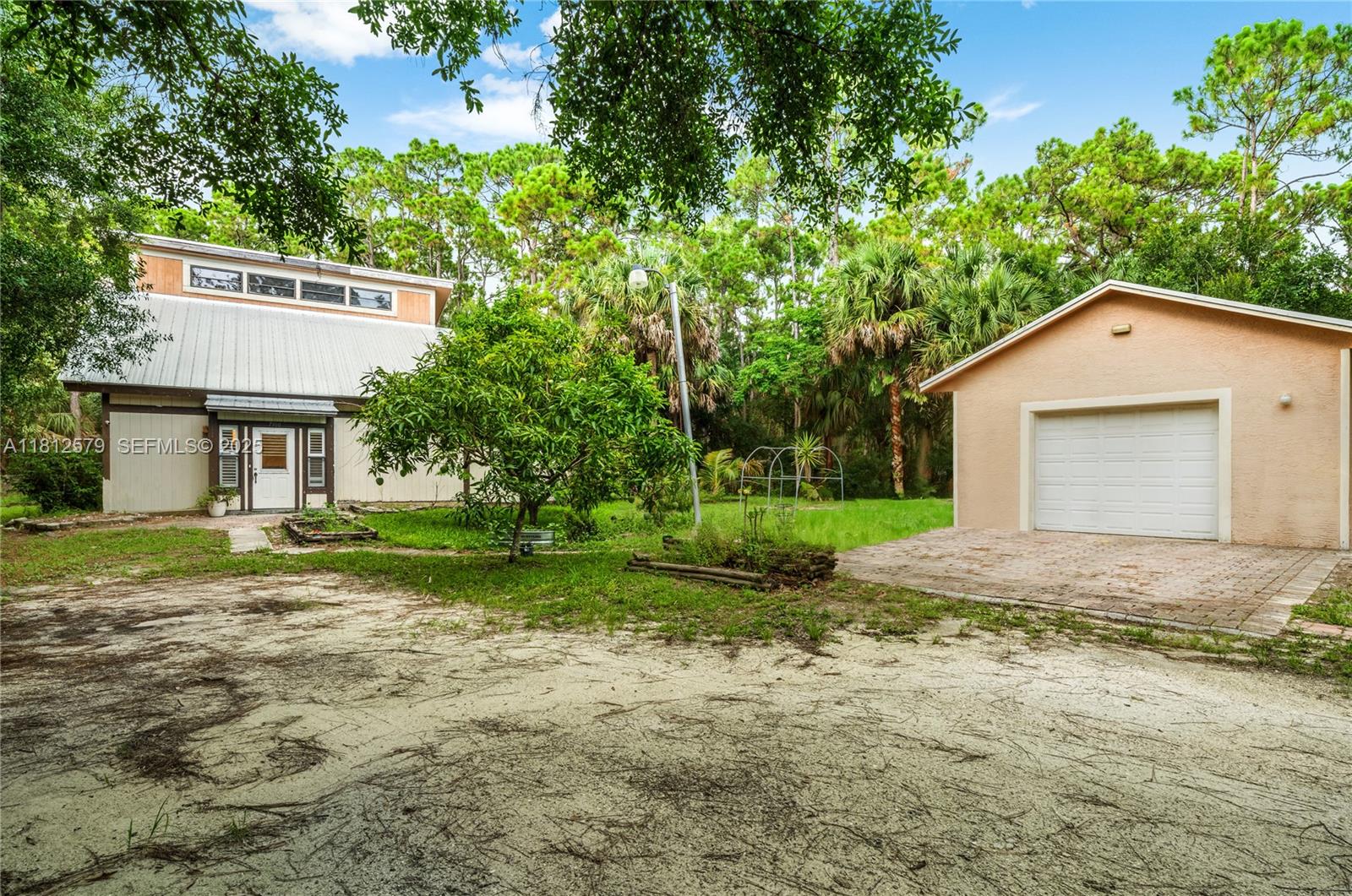 7900 Southwest Springhaven Avenue Indiantown, FL 34956 - Photo 3 of 38 a front view of a house with a yard and garage