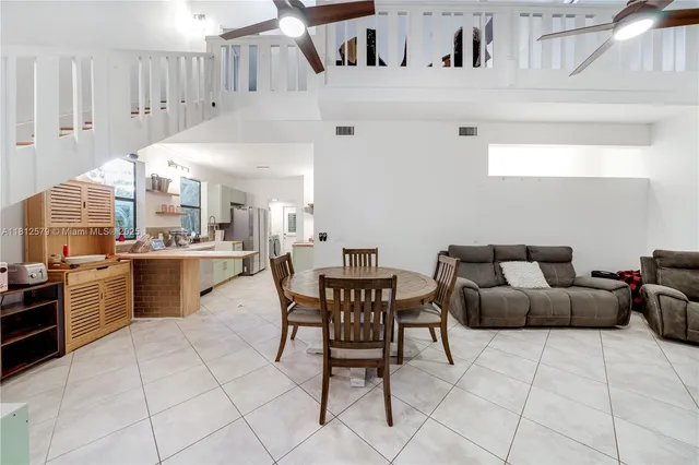 a living room with granite countertop furniture and kitchen view