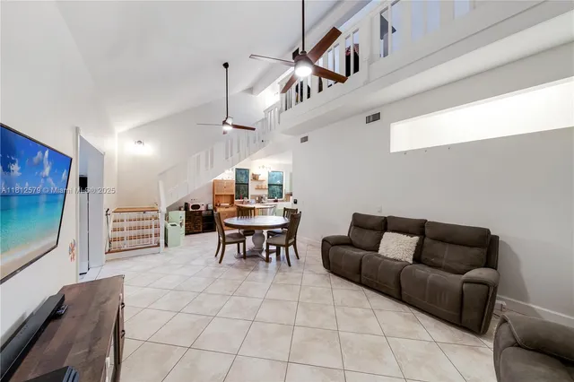 a living room with furniture a dining table and a piano