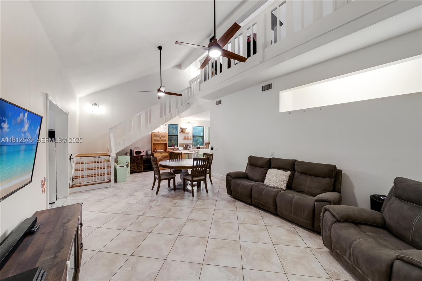 7900 Southwest Springhaven Avenue Indiantown, FL 34956 - Photo 9 of 38 a living room with furniture and a flat screen tv