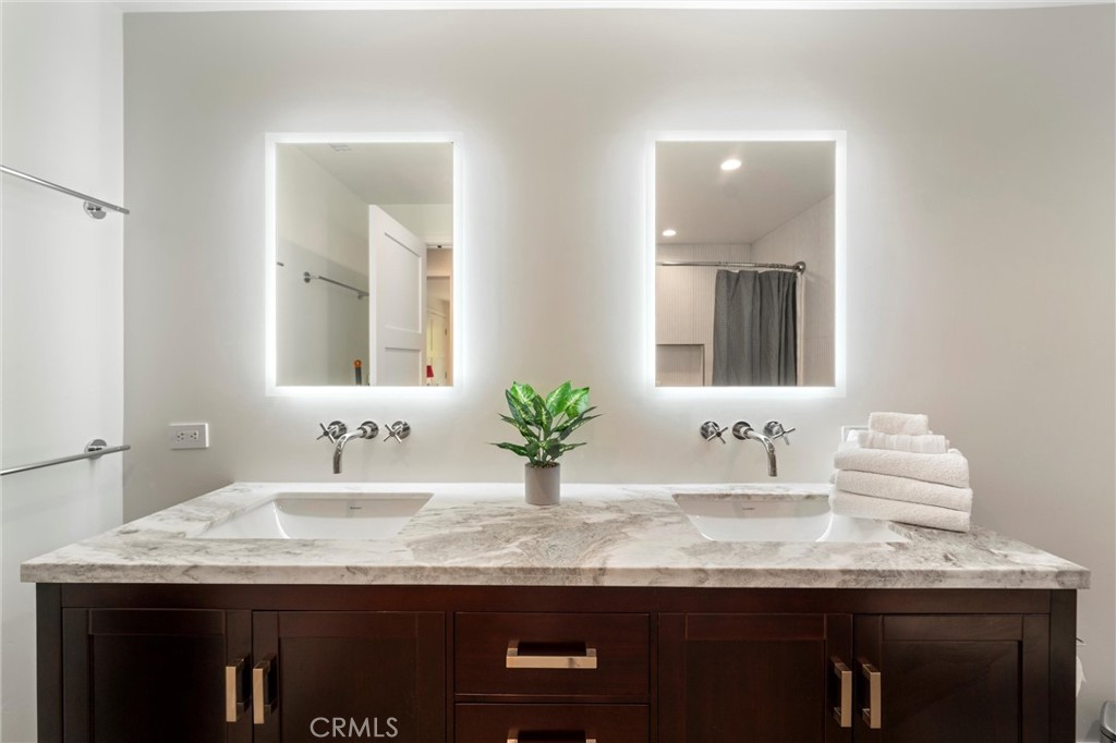 7337 La Soldadera Rancho Santa Fe, CA 92067 - Photo 27 of 60 a bathroom with a granite countertop sink and a mirror