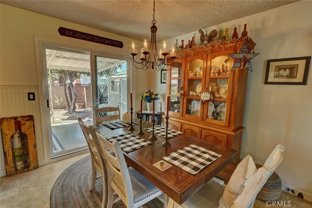 a view of a dining room with furniture and chandelier