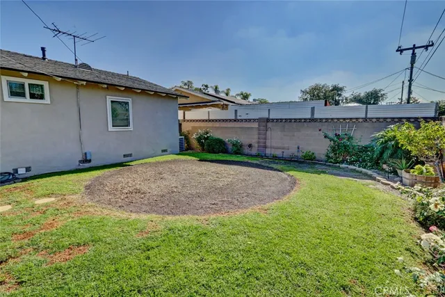 a view of a backyard with plants and a patio