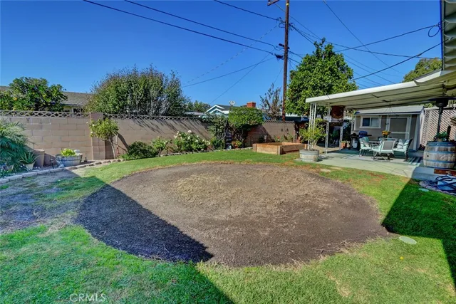 a view of a patio with a table and chairs under an umbrella