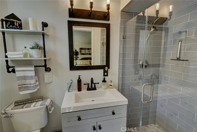 a bedroom with a bed and a view of living room