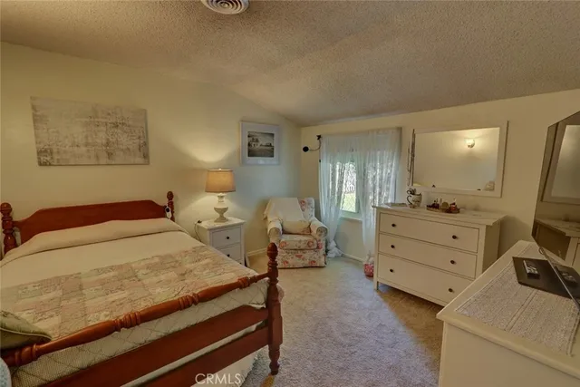 a spacious bedroom with a bed and a window