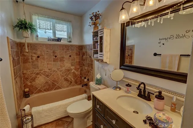 a bedroom with a bed and a refrigerator