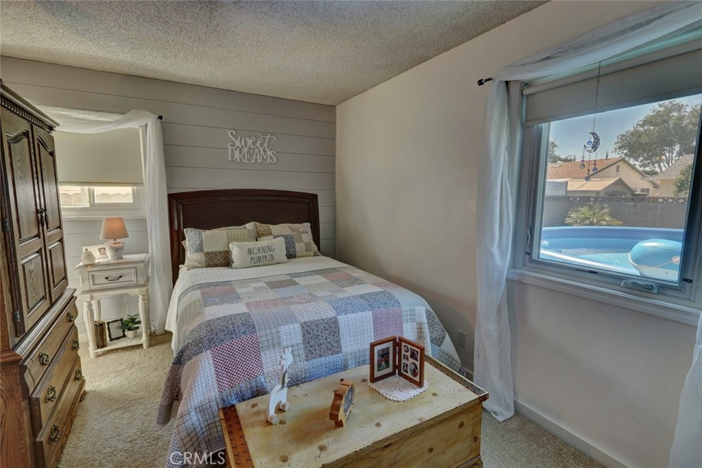 10291 Wyatt Road Stanton, CA 90680 - Photo 35 of 36 a bedroom with a bed and a window