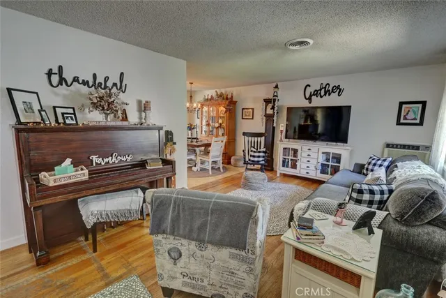 a living room with furniture a flat screen tv and a table