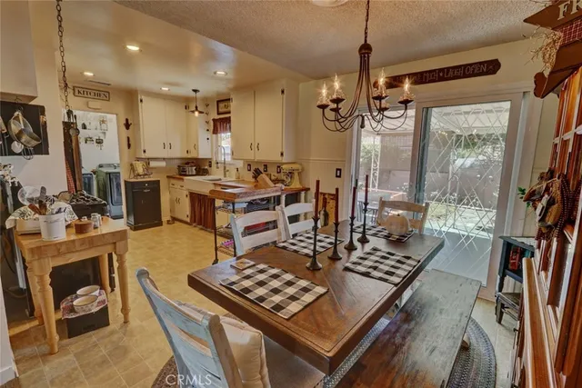 a view of a kitchen with a dining table chairs and a stove