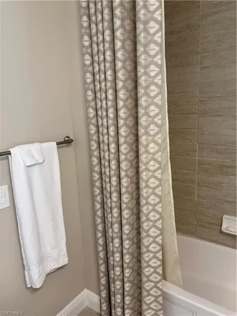 a bathroom with a shower curtain and a sink