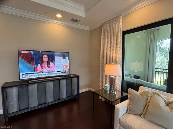 a living room with furniture pool and a large window