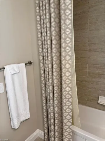 a bathroom with a shower curtain and a sink