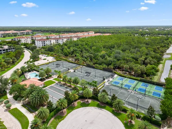 an aerial view of residential houses with outdoor space and swimming pool