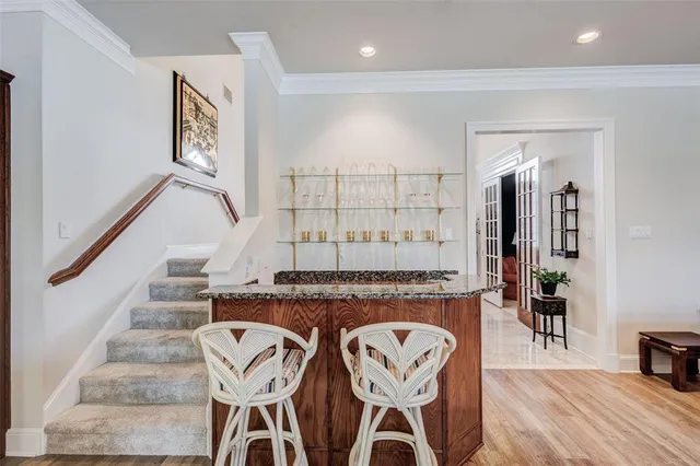 a view of a hallway with wooden floor and entryway