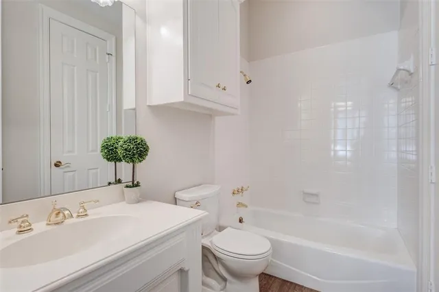 a bedroom with a bed a chandelier and a window