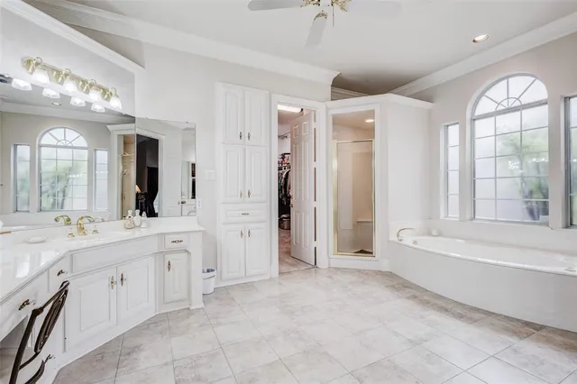 a view of bathroom with bathtub cabinet and mirror