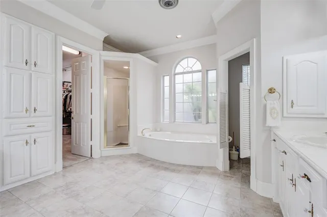 a spacious bathroom with a granite countertop sink a toilet a mirror and shower
