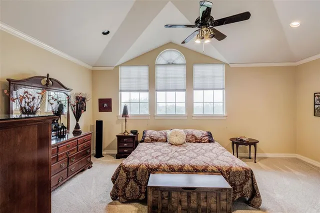 a bedroom with a large bed and a chandelier