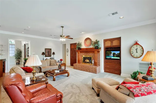 a living room with furniture a fireplace and window