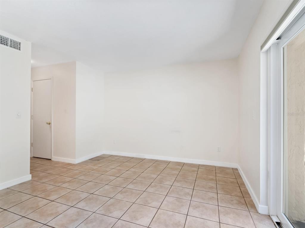 4805 Rilma Avenue, Unit 107 Sarasota, FL 34234 - Photo 11 of 42 a view of an empty room and window