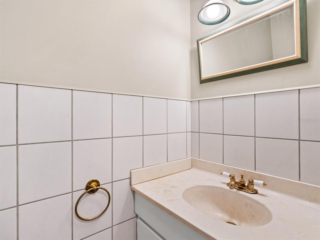 4805 Rilma Avenue, Unit 107 Sarasota, FL 34234 - Photo 16 of 42 a bathroom with a sink vanity and mirror