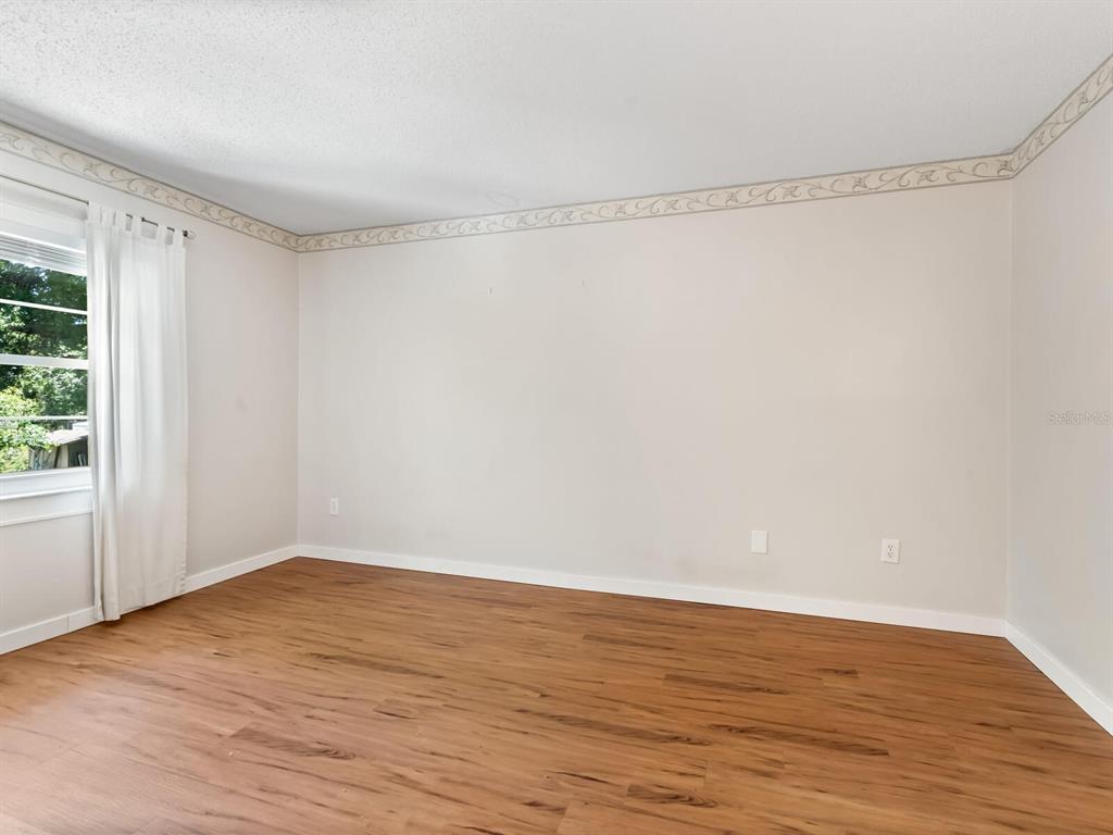 4805 Rilma Avenue, Unit 107 Sarasota, FL 34234 - Photo 18 of 42 a view of a room with wooden floor and small window