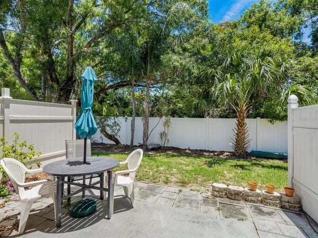 a swimming pool with outdoor seating and yard