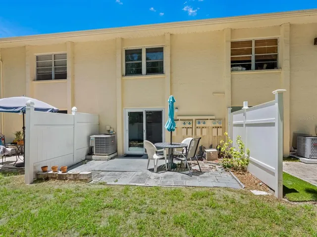 a view of a house with backyard porch and sitting area