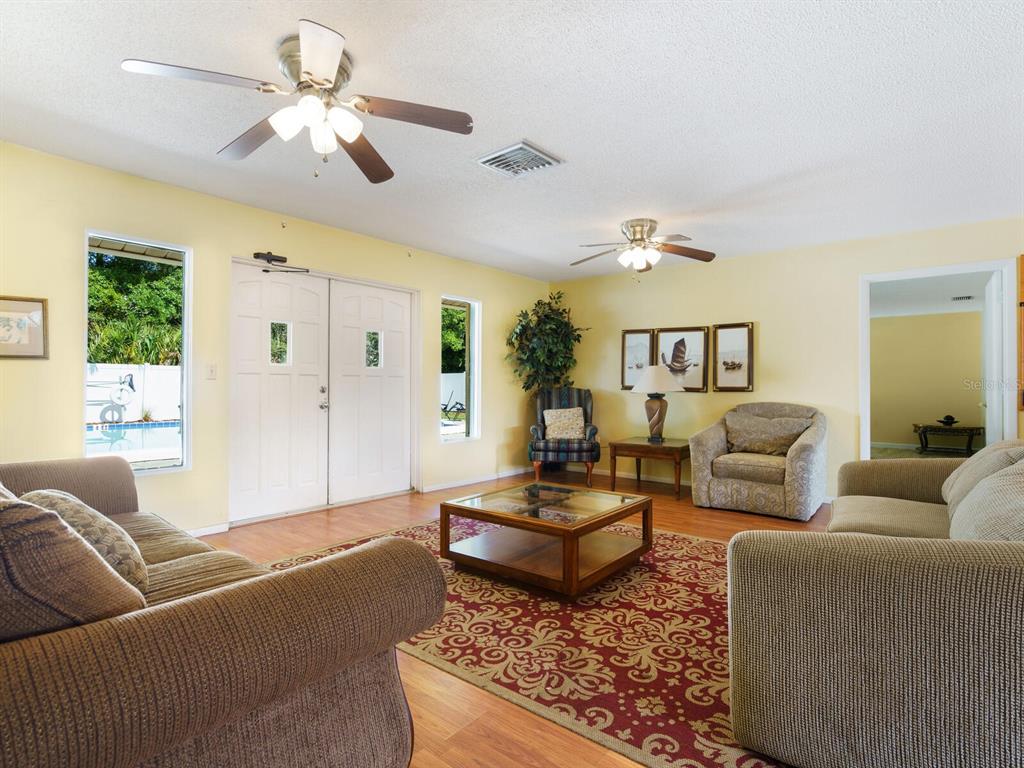 4805 Rilma Avenue, Unit 107 Sarasota, FL 34234 - Photo 33 of 42 a living room with furniture ceiling fan and a window