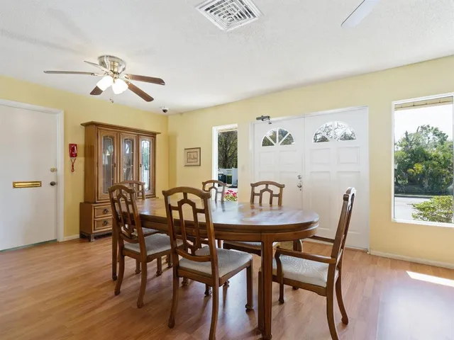a view of a dining room with furniture and wooden floor