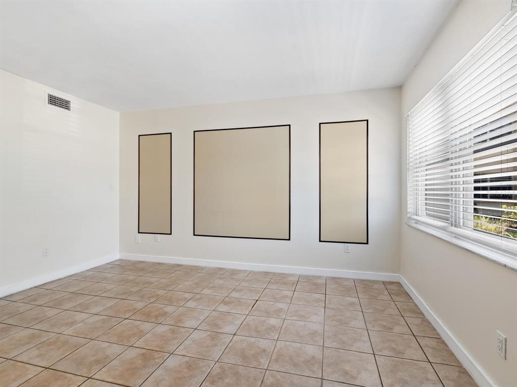4805 Rilma Avenue, Unit 107 Sarasota, FL 34234 - Photo 5 of 42 an empty room with windows