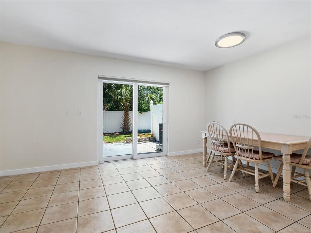 4805 Rilma Avenue, Unit 107 Sarasota, FL 34234 - Photo 8 of 42 a dining room with furniture and a window