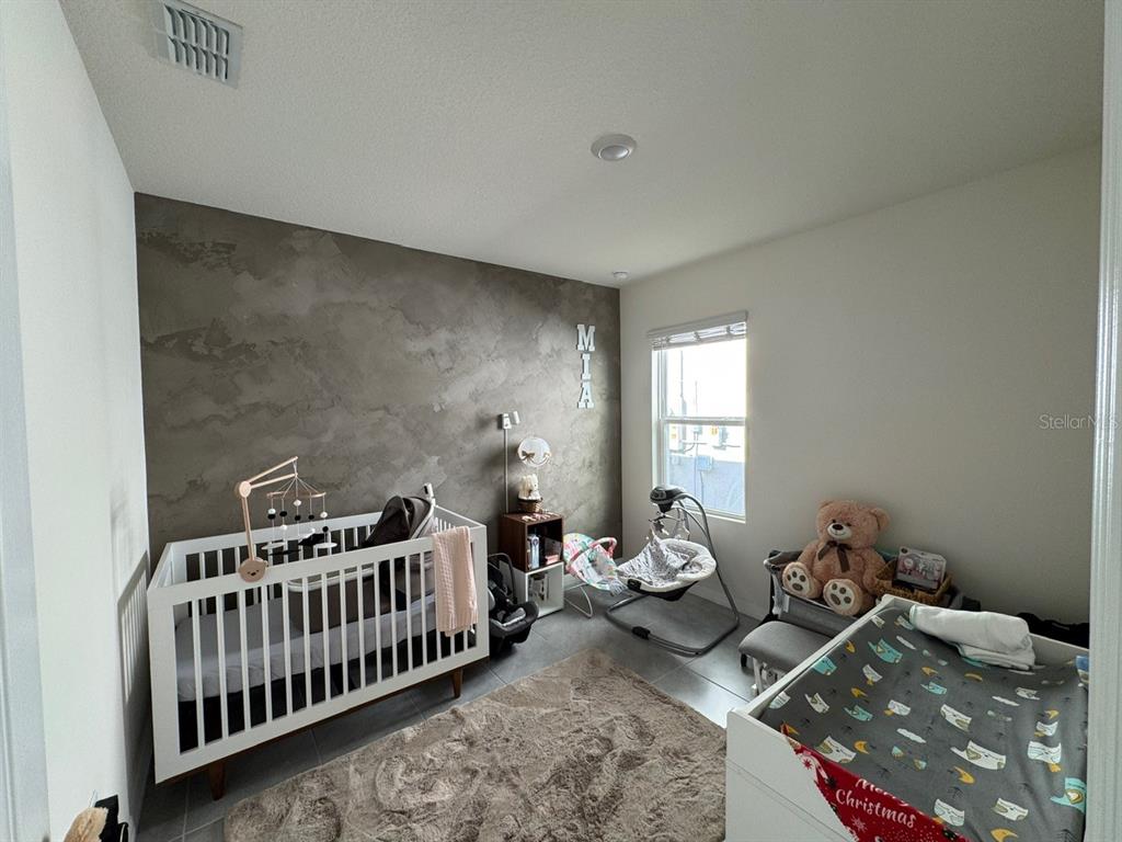 2843 Turnstone Run Harmony, FL 34773 - Photo 11 of 39 a bedroom with furniture and a window