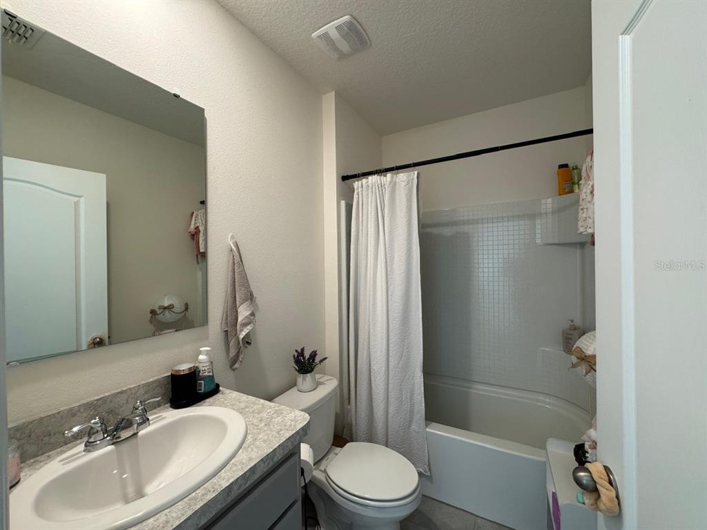 2843 Turnstone Run Harmony, FL 34773 - Photo 14 of 39 a bathroom with a sink toilet and shower