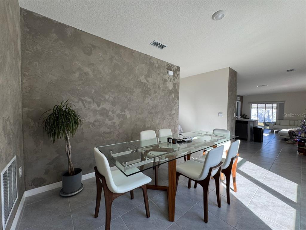 2843 Turnstone Run Harmony, FL 34773 - Photo 19 of 39 a view of a dining room with furniture and wooden floor