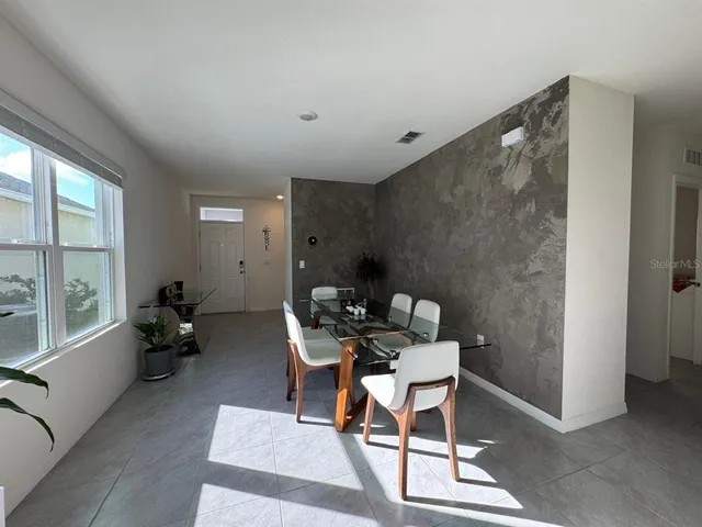 a work room with furniture and a large window
