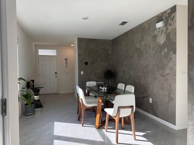 a dining room with furniture and wooden floor