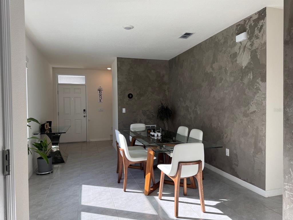 2843 Turnstone Run Harmony, FL 34773 - Photo 21 of 39 a dining room with furniture and wooden floor